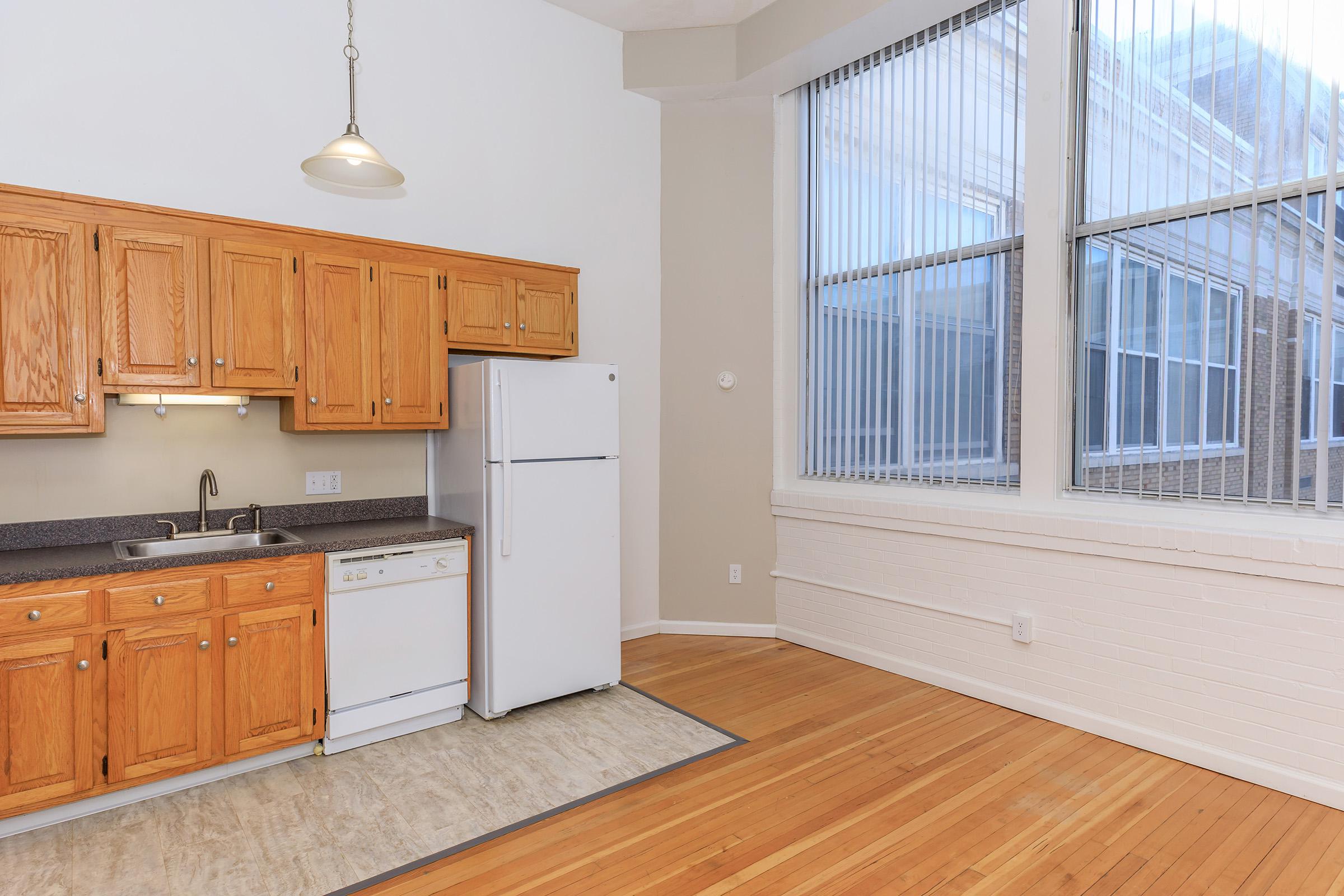 a kitchen with wooden cabinets