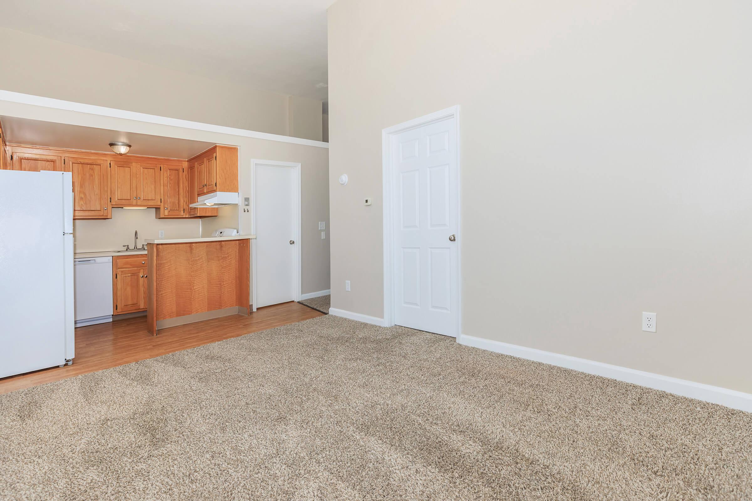 a kitchen with wooden cabinets and a refrigerator