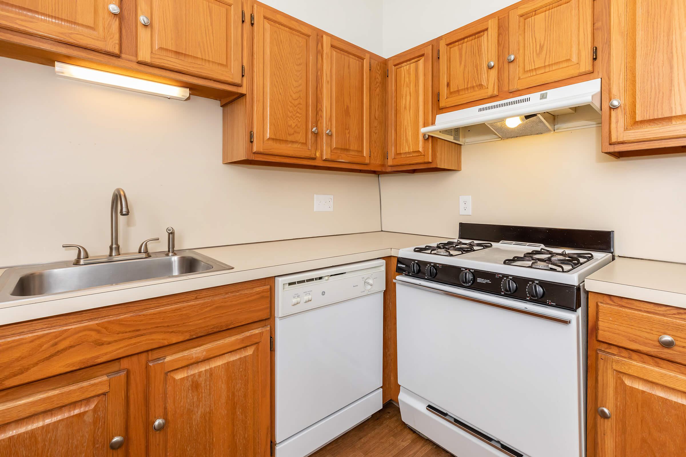 a kitchen with stainless steel appliances and wooden cabinets