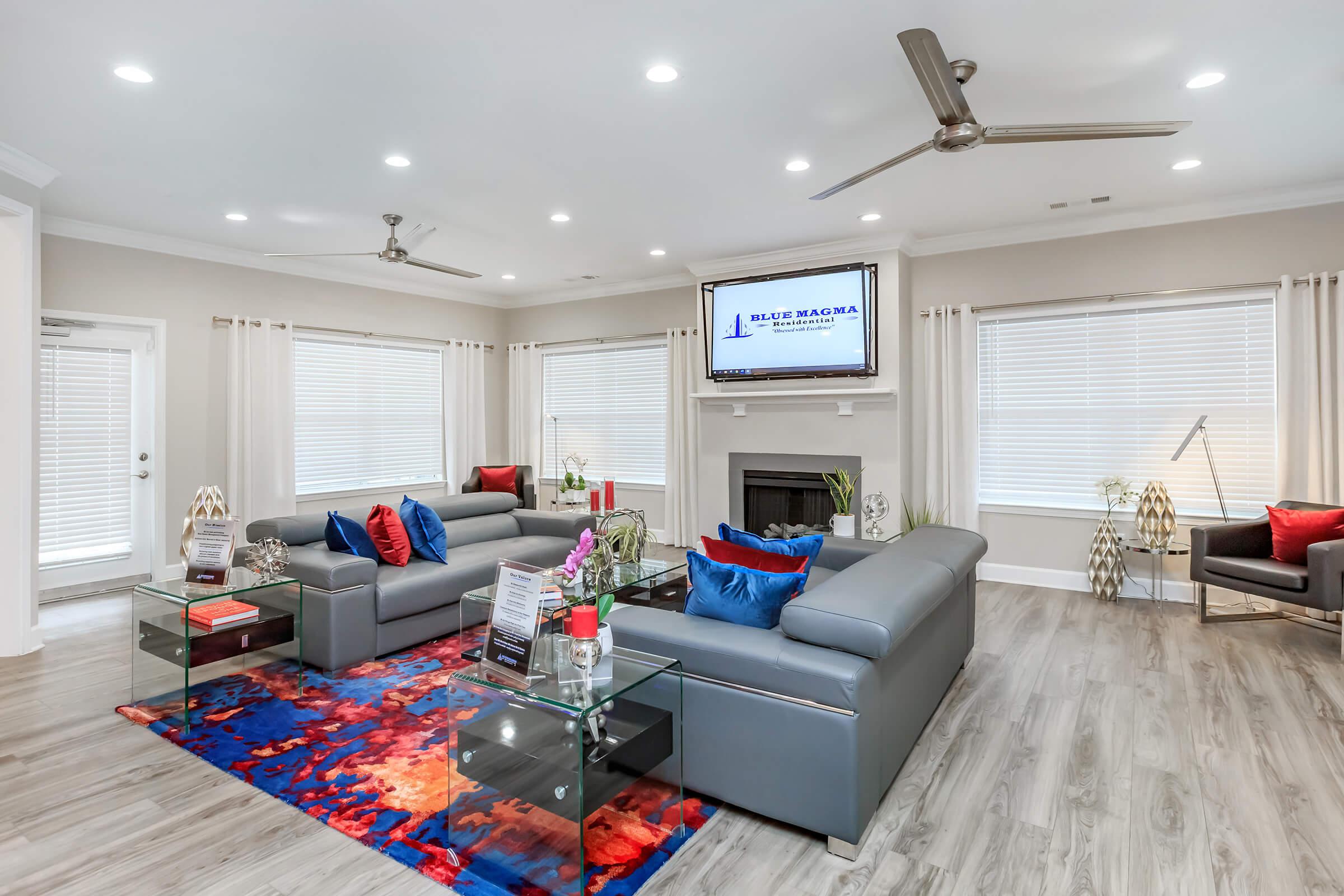 a living room filled with furniture and a flat screen tv