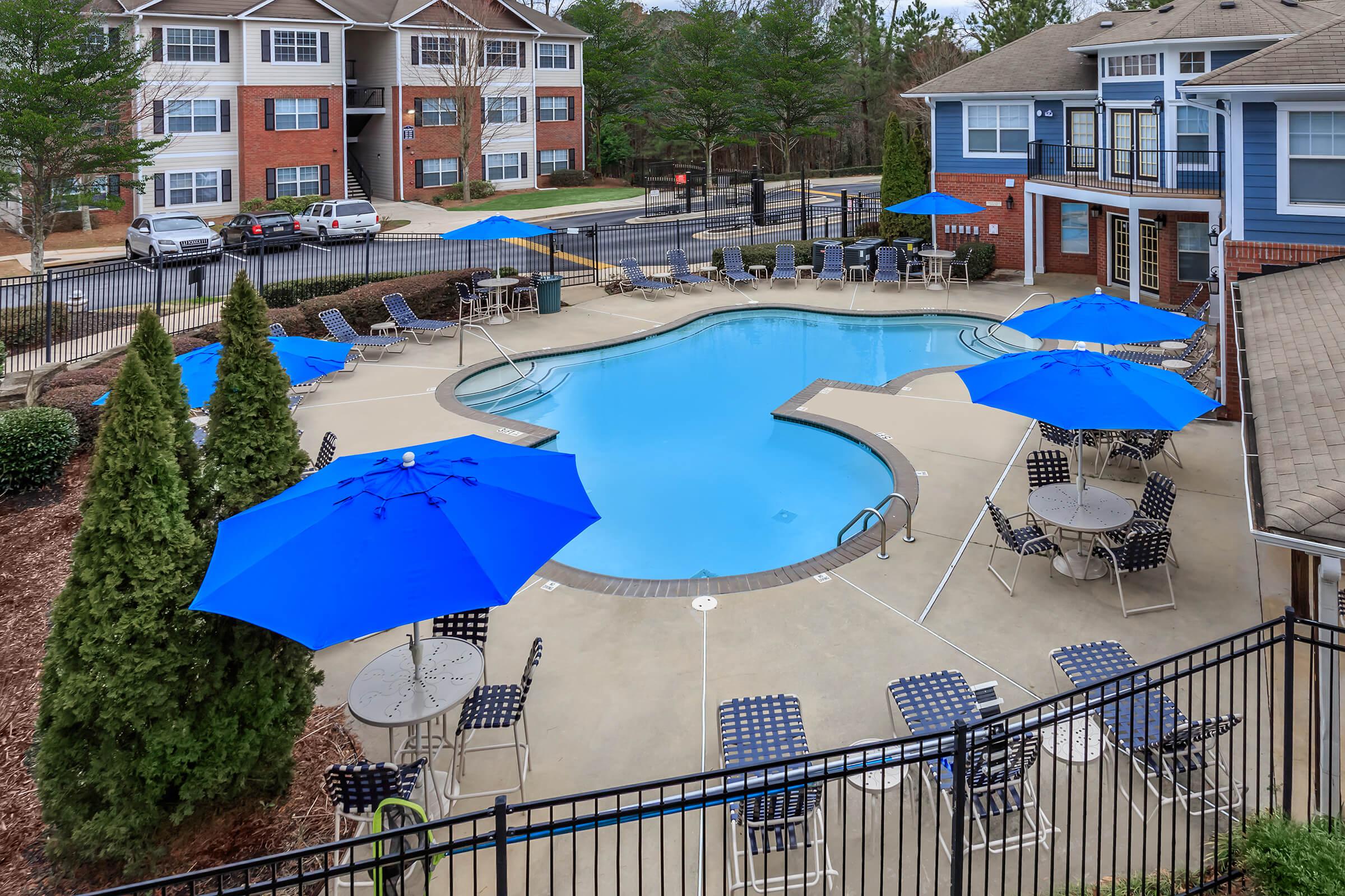 a house with a pool in front of a building