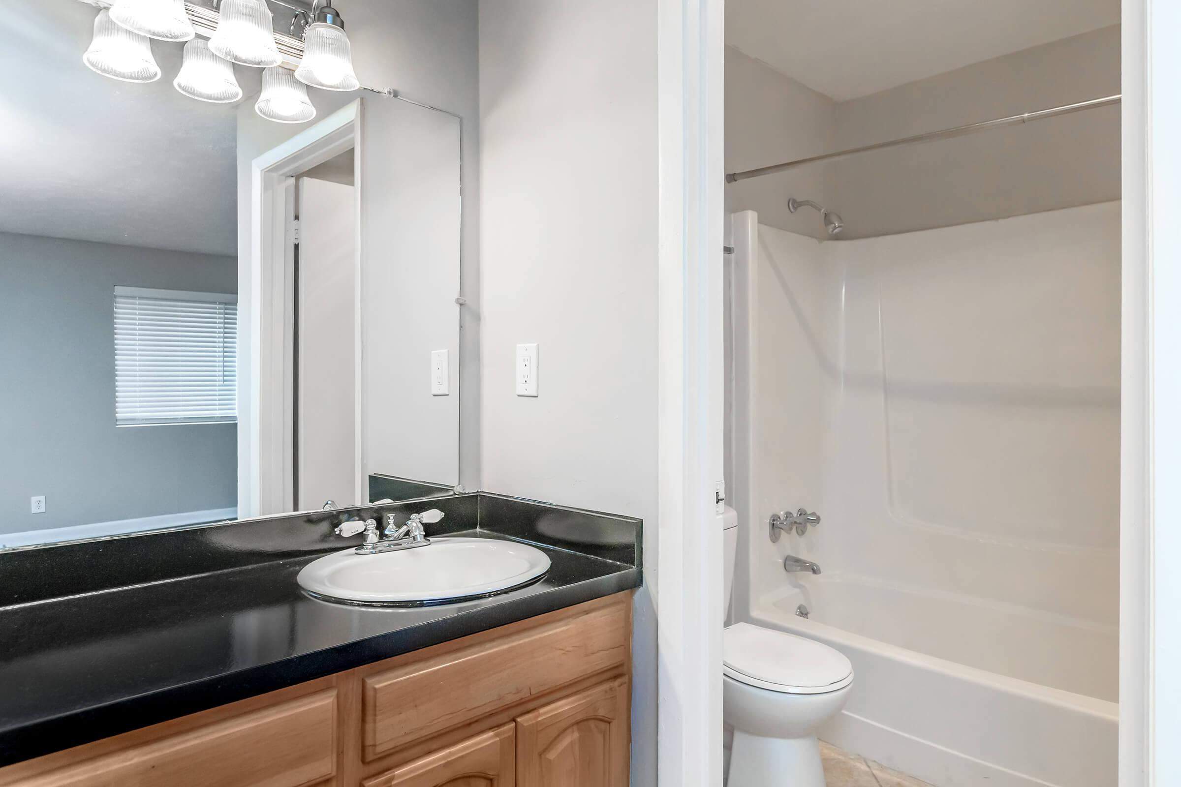 a white sink sitting under a window