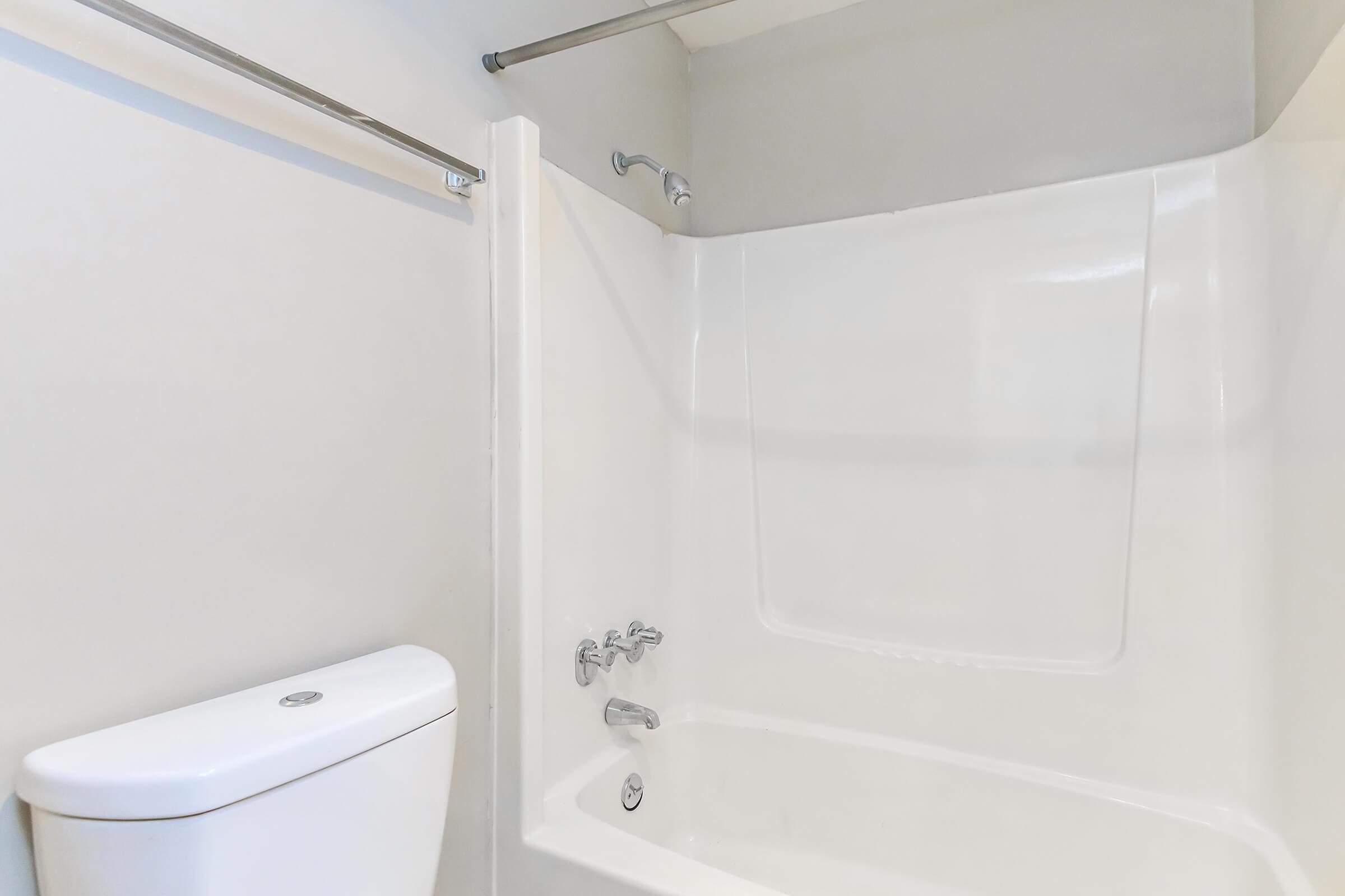 a white tub sitting next to a shower