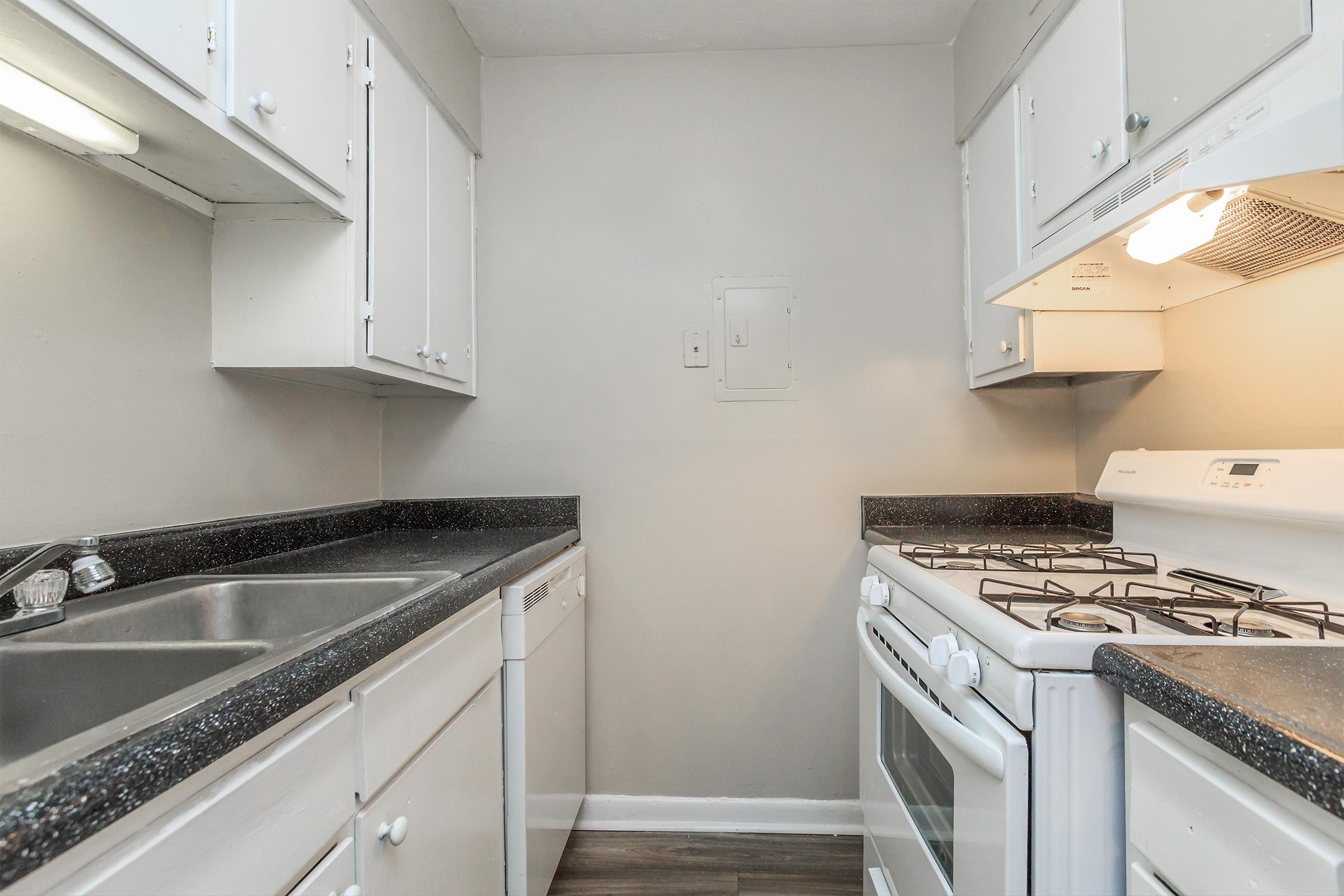 a kitchen with a stove and a sink