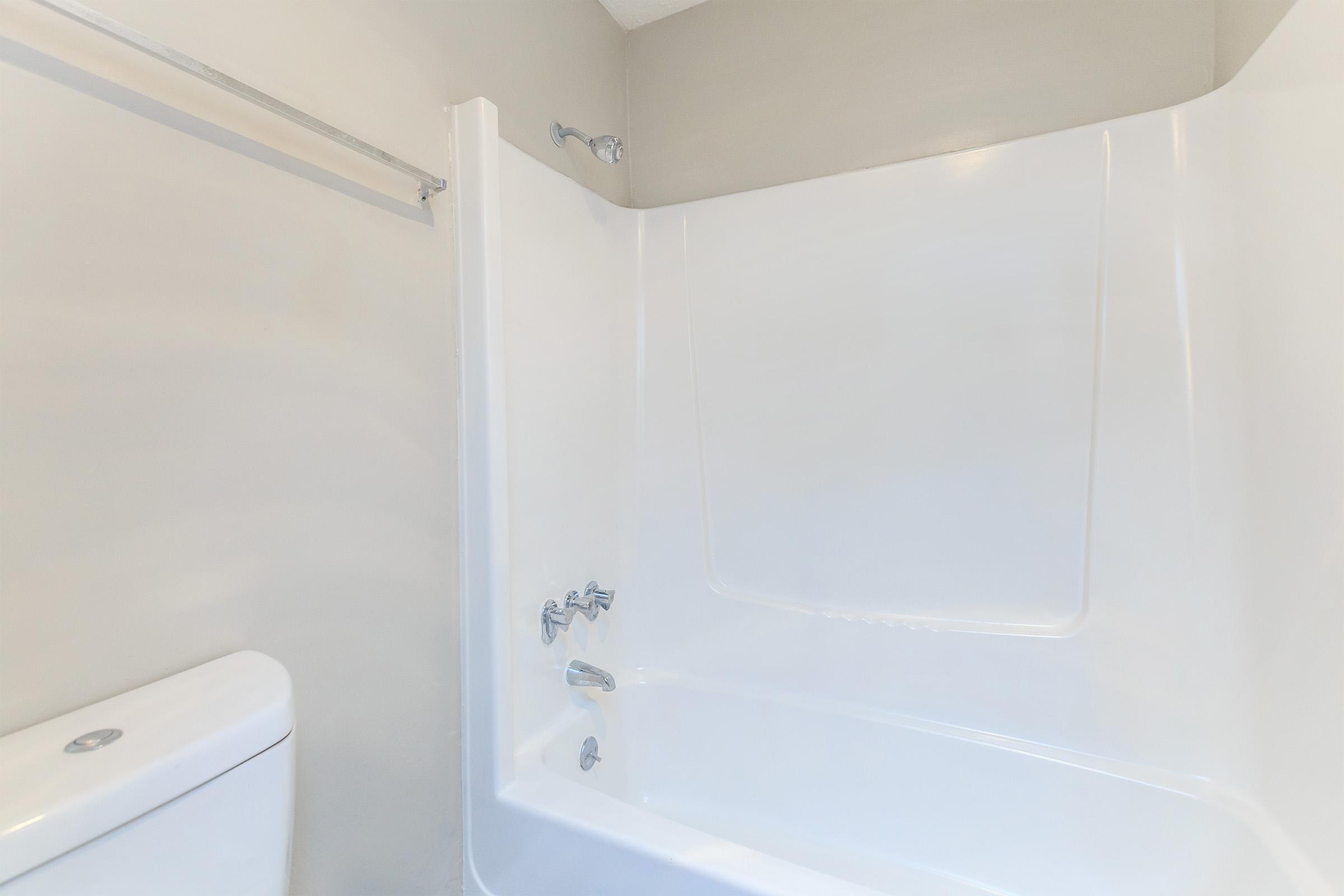 a white tub sitting next to a shower