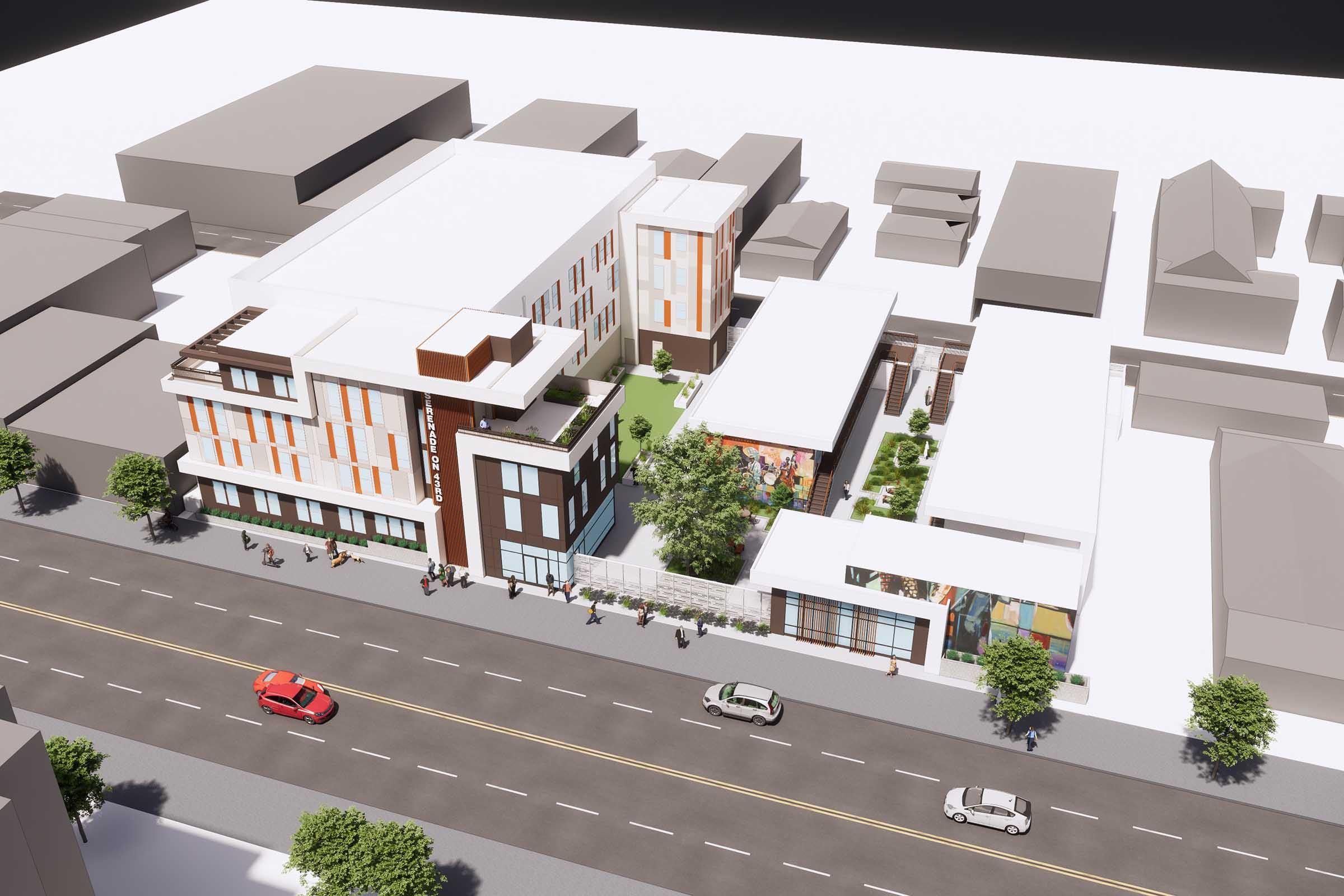 Aerial view of a modern building complex featuring a multi-story structure with balconies and a rooftop green space. Surrounding the main building are smaller structures and landscaped areas, with trees lining the sidewalks. Streets with cars can be seen in front of the complex, illustrating a lively urban environment.