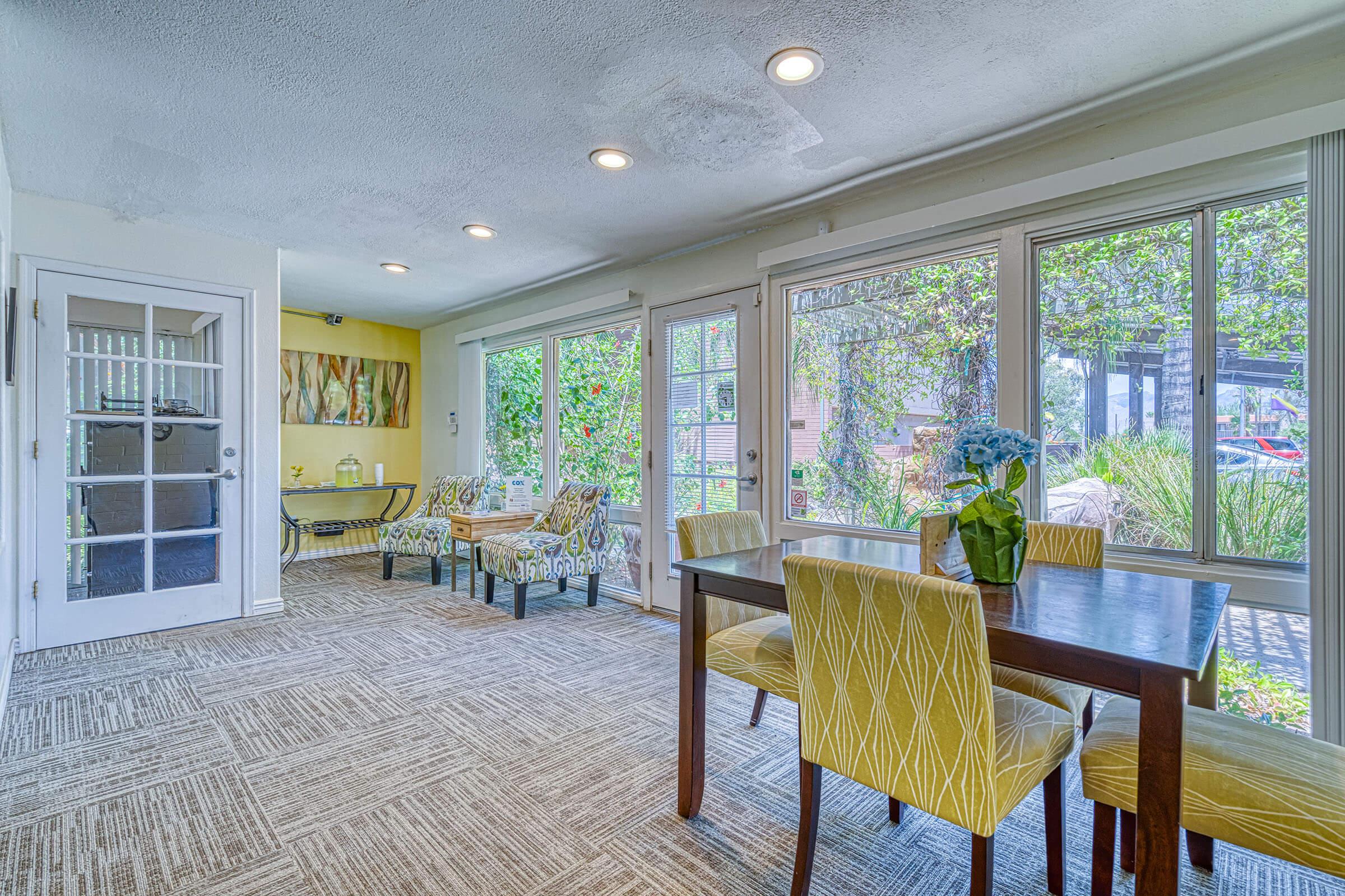 a living room filled with furniture and a large window