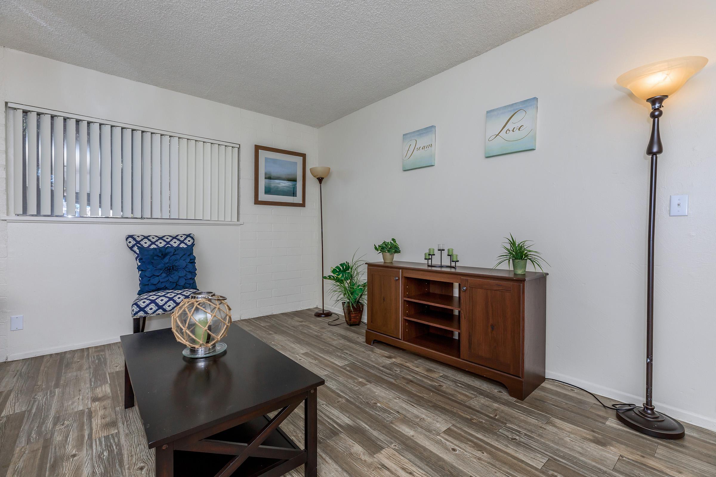 a living room filled with furniture and a flat screen tv