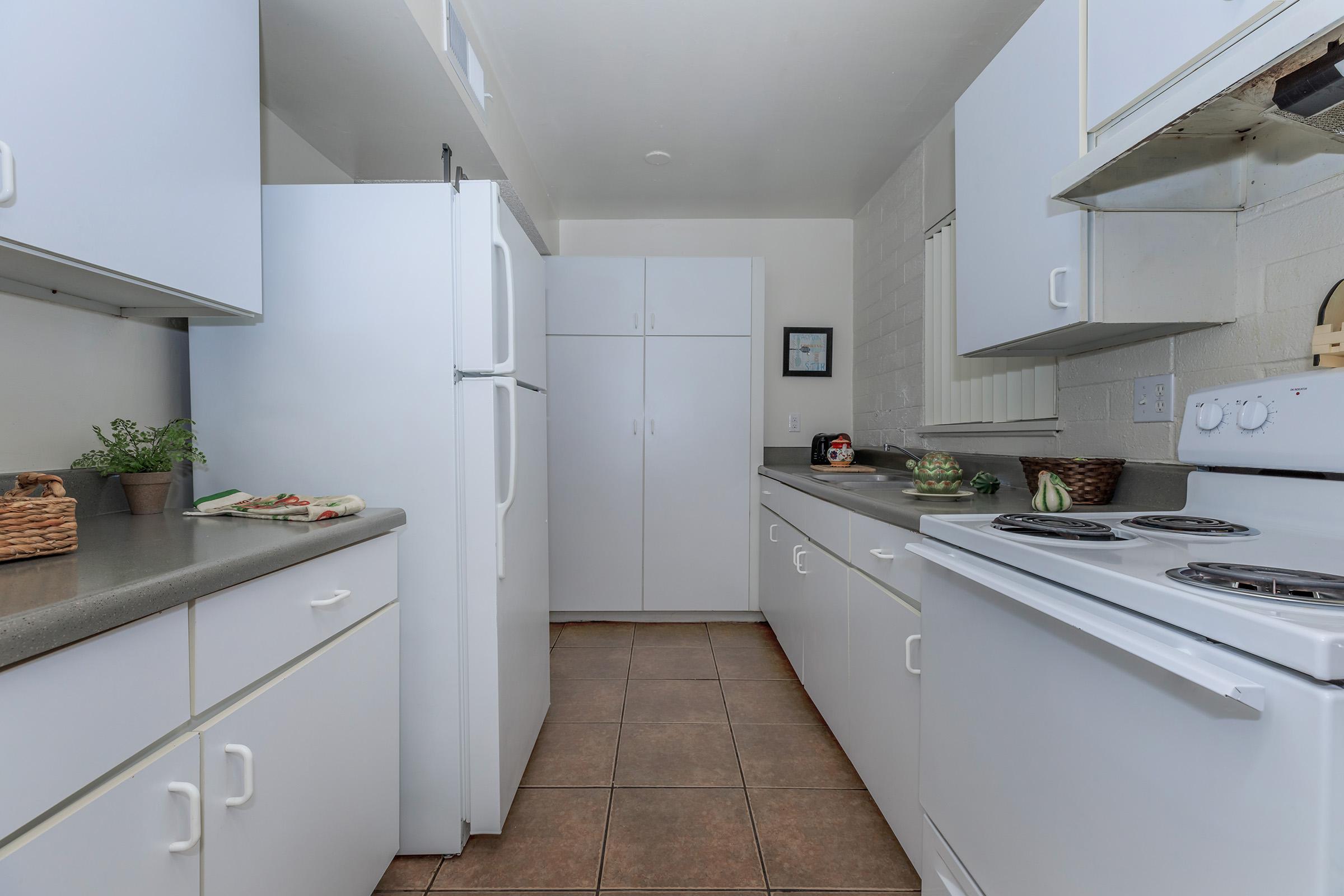 a kitchen with a sink and a refrigerator