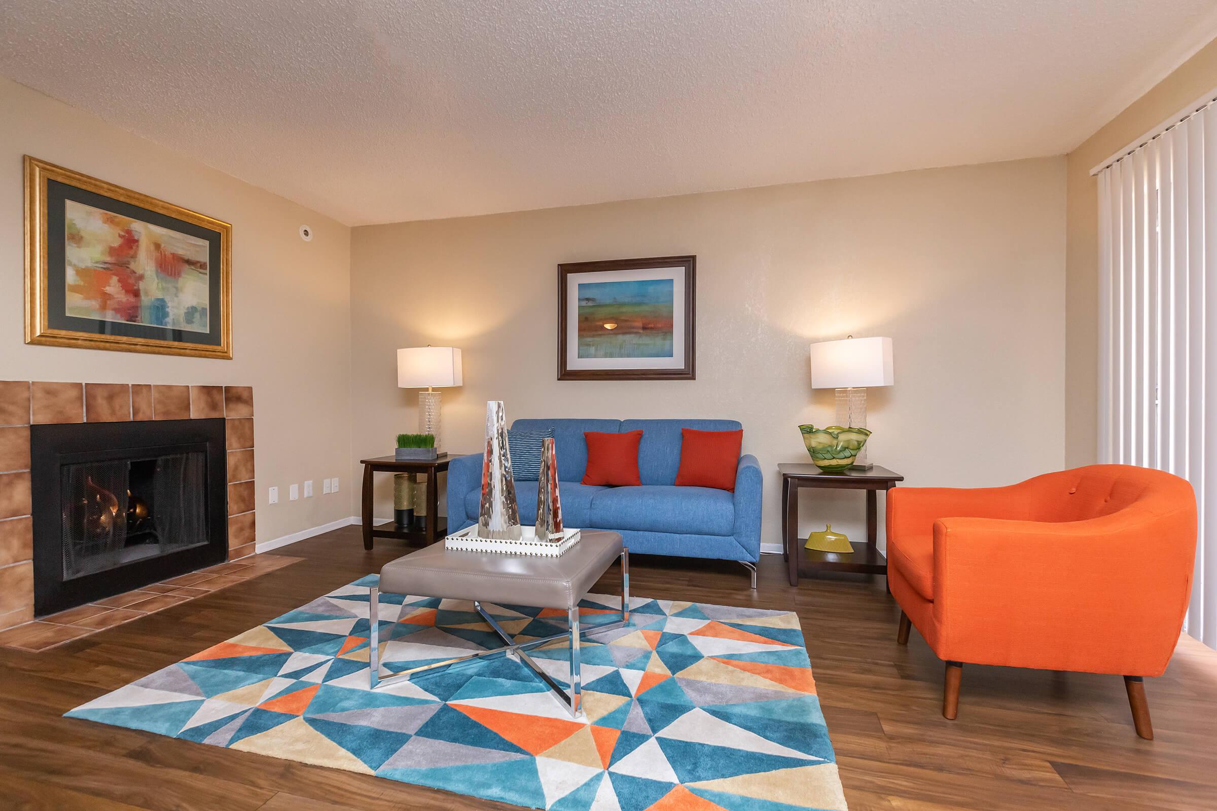 a living room filled with furniture and a red rug