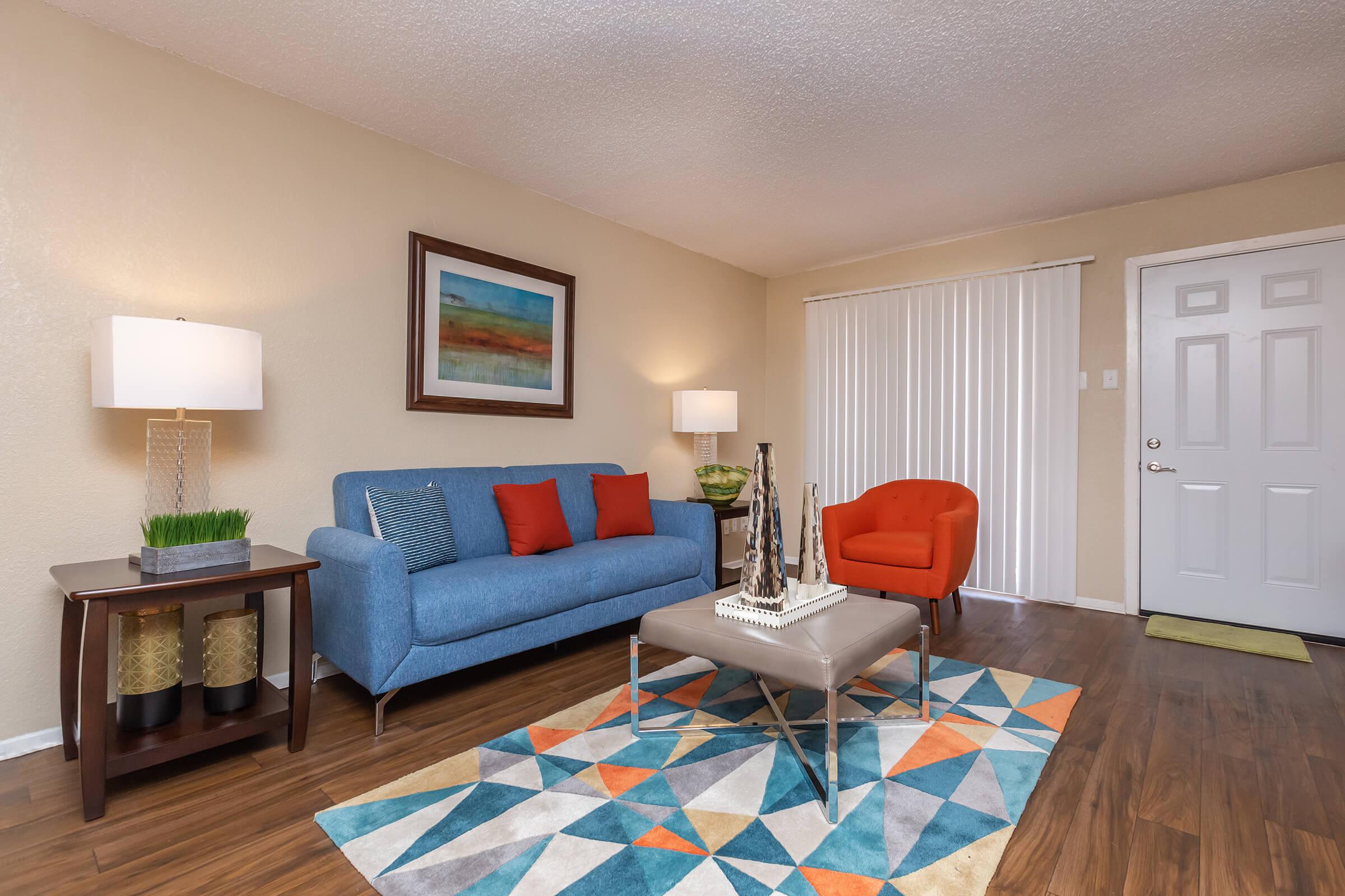 a living room filled with furniture and a rug