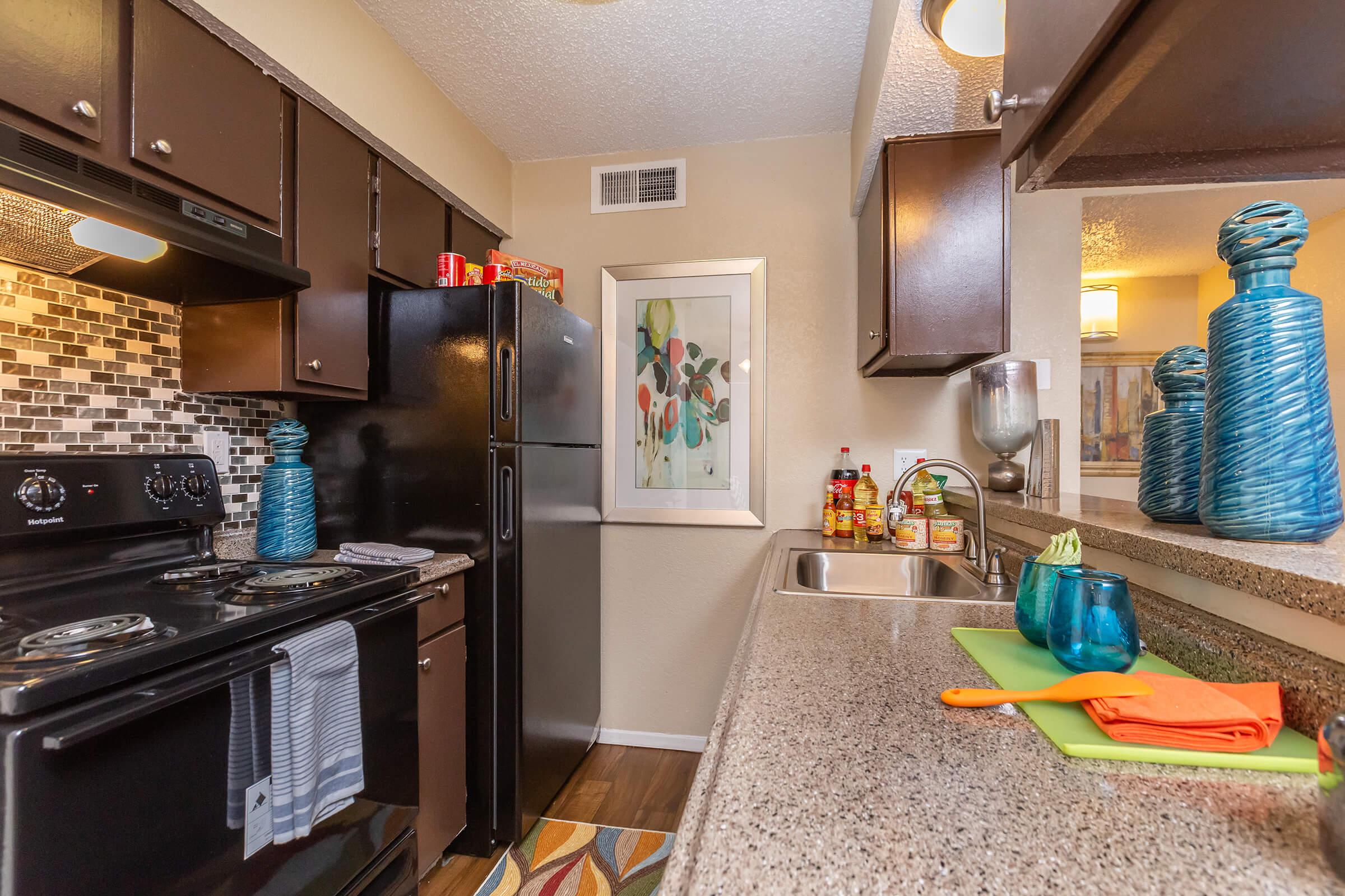 a stove top oven sitting inside of a kitchen