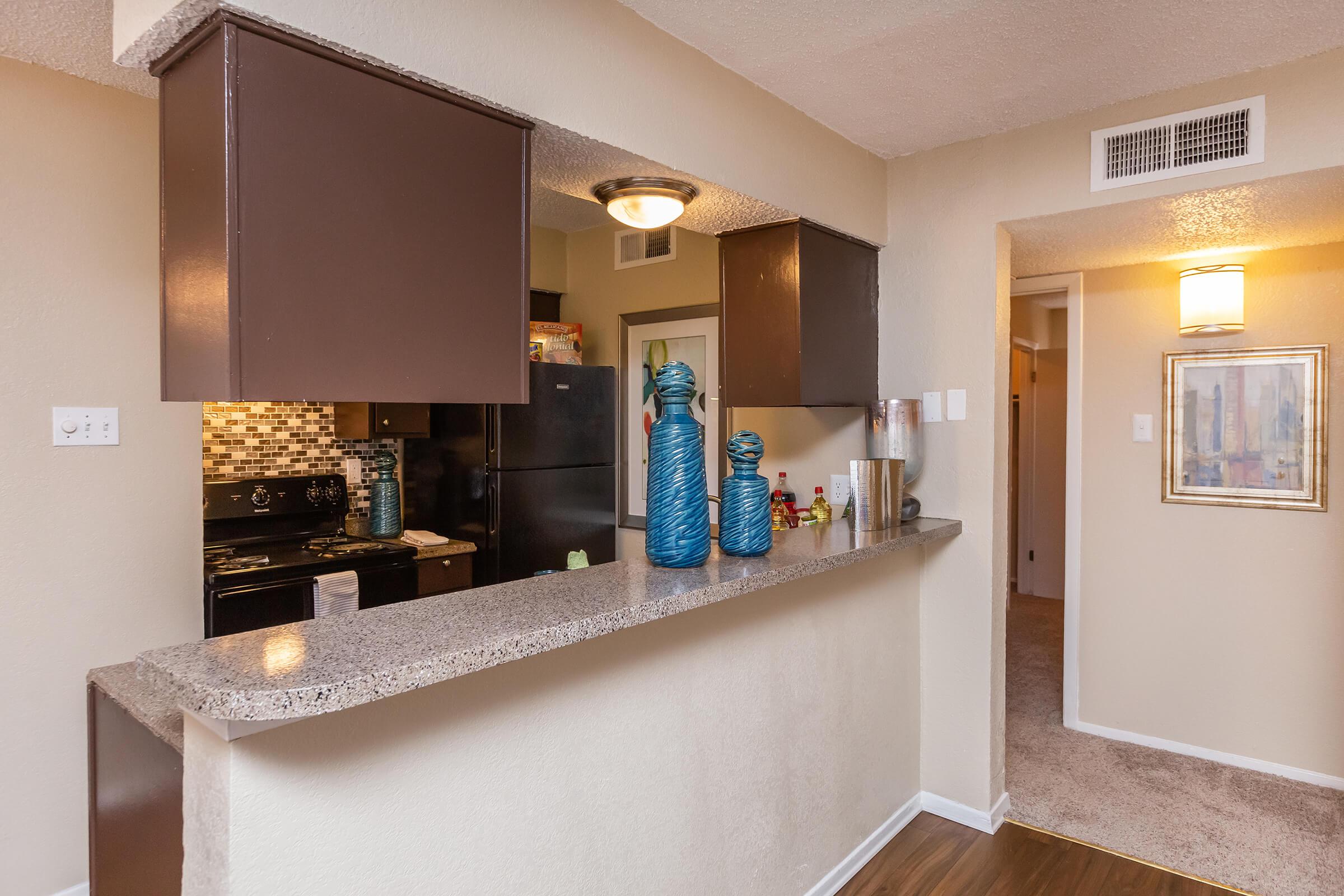 a kitchen with a sink and a refrigerator