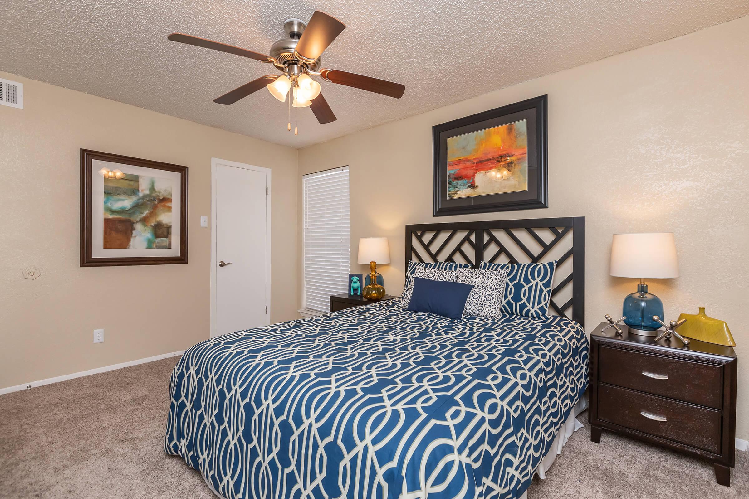 a bedroom with a bed and desk in a small room