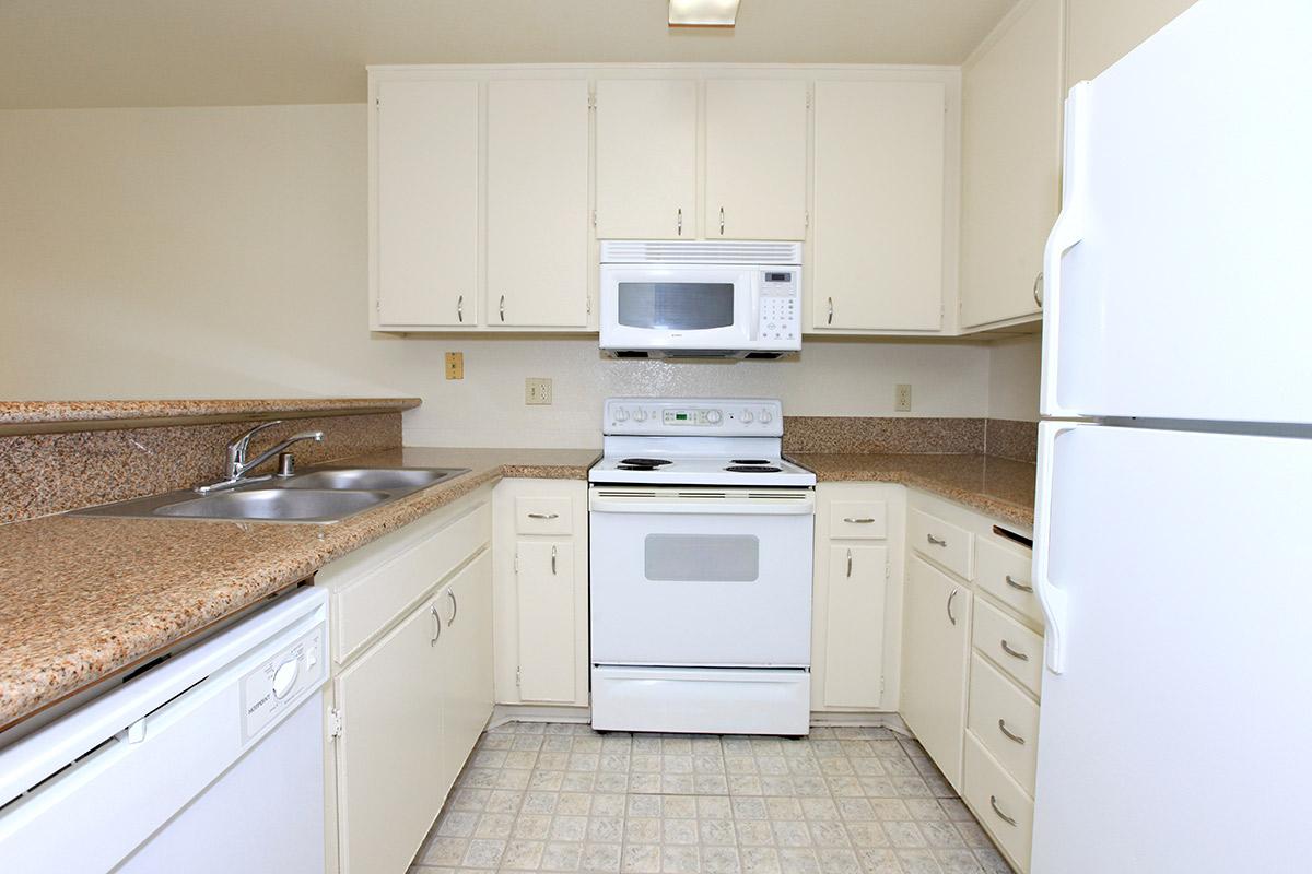 a kitchen with a white stove top oven sitting inside of a refrigerator