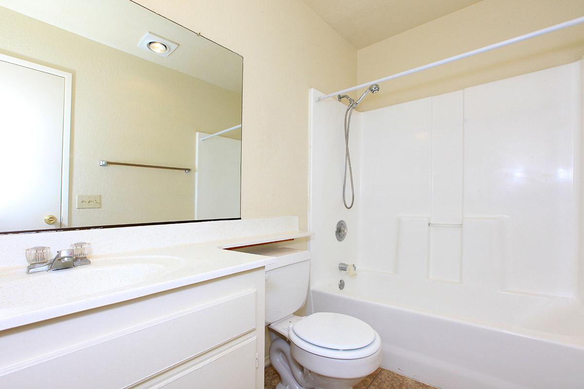 a white tub sitting next to a shower