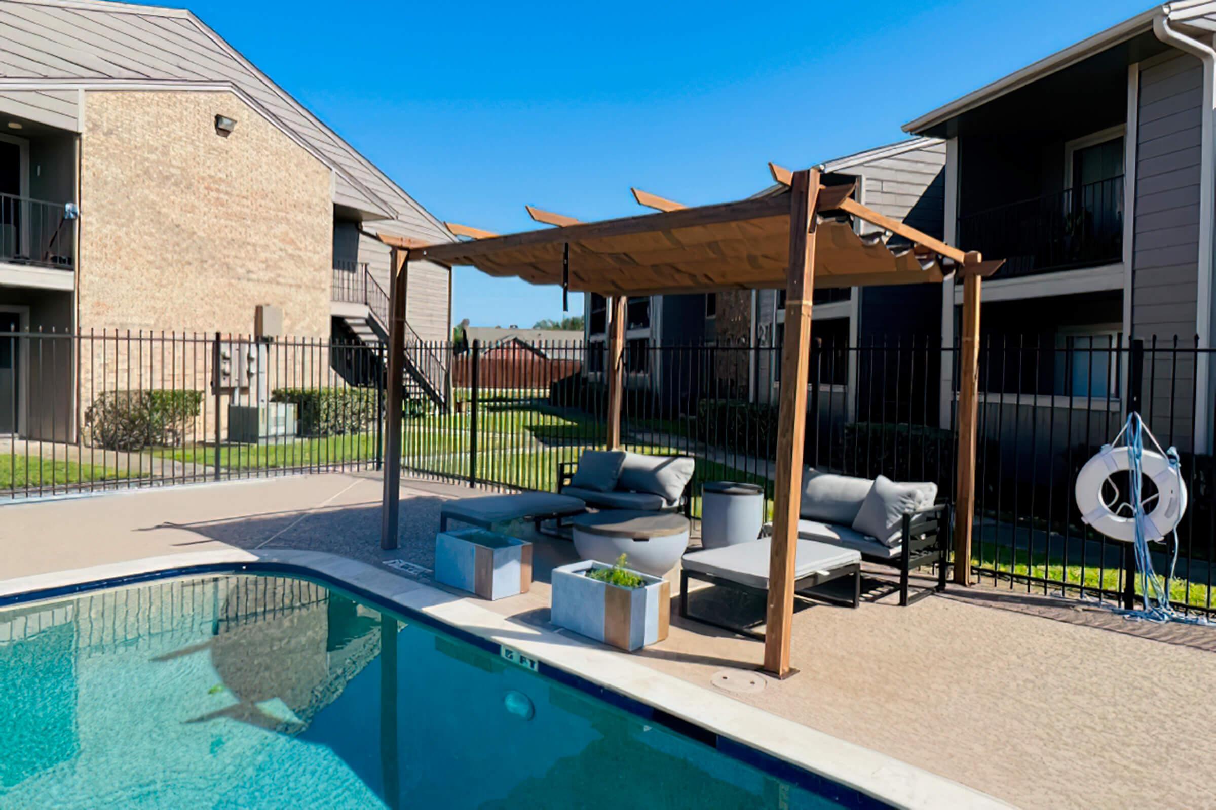 a house with a pool in front of a building