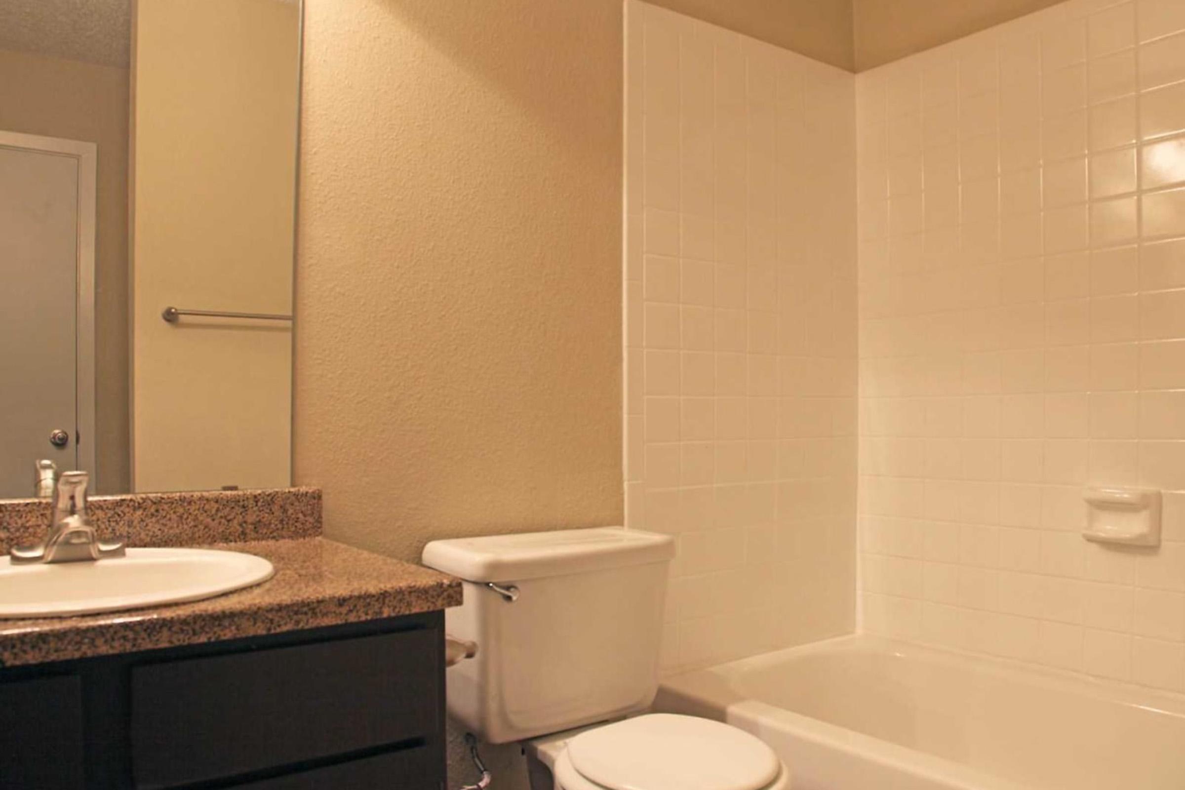 a white sink sitting next to a shower