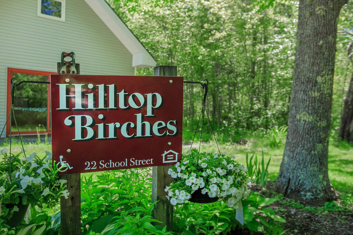 a sign in front of a tree