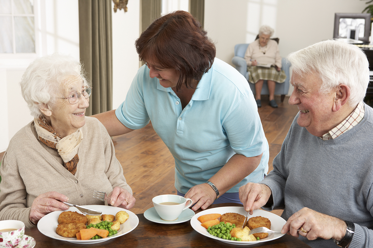 a person sitting at a table with a plate of food