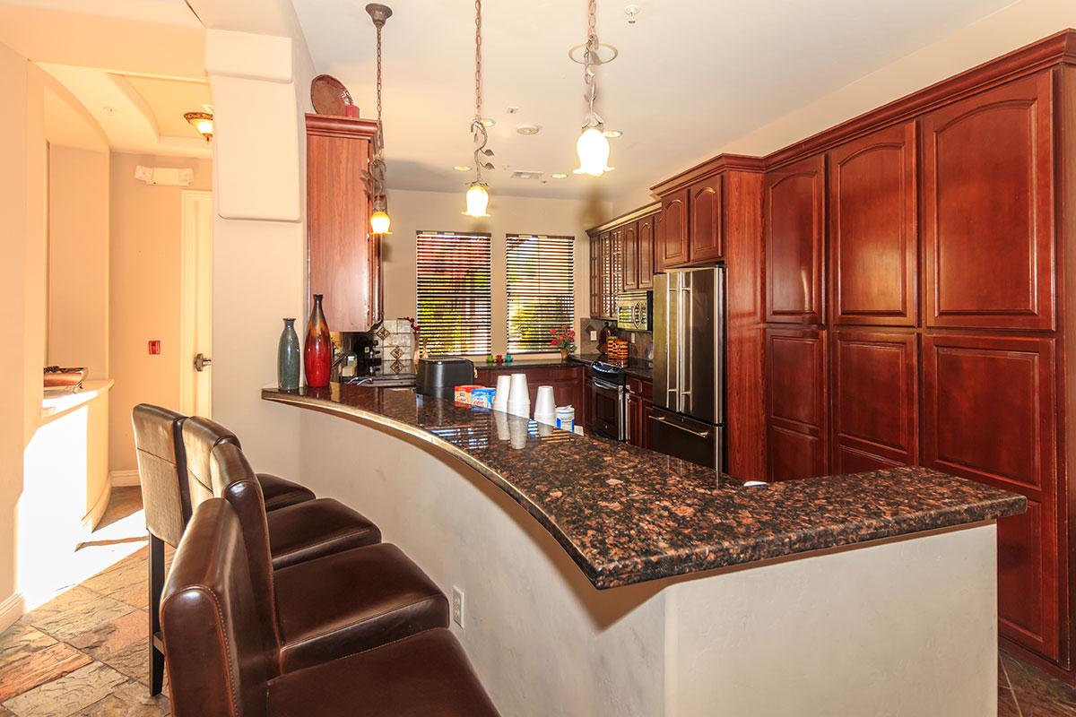 a large kitchen with stainless steel appliances and wooden cabinets