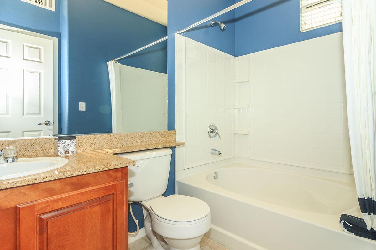 a large white tub next to a sink