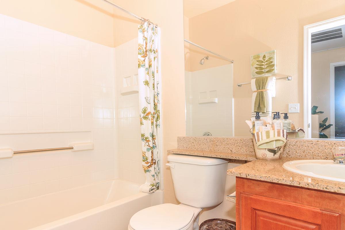 a white tub sitting next to a sink