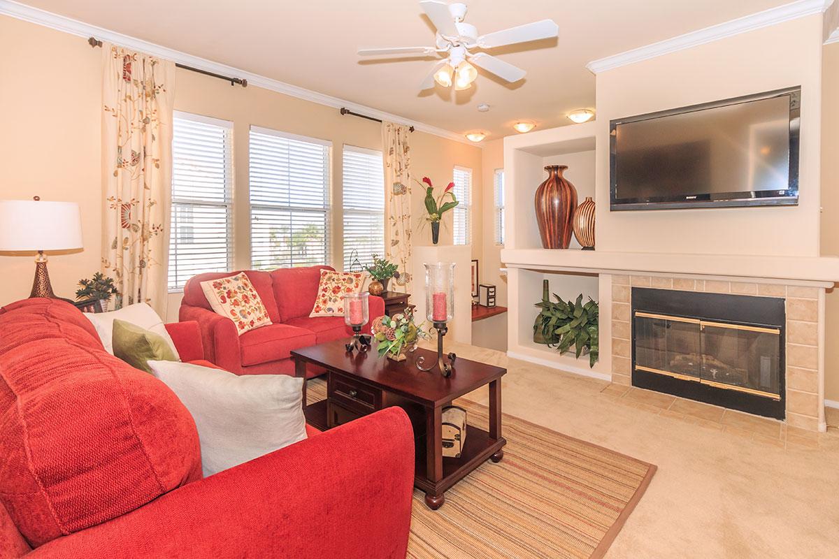 a living room filled with furniture and a flat screen tv