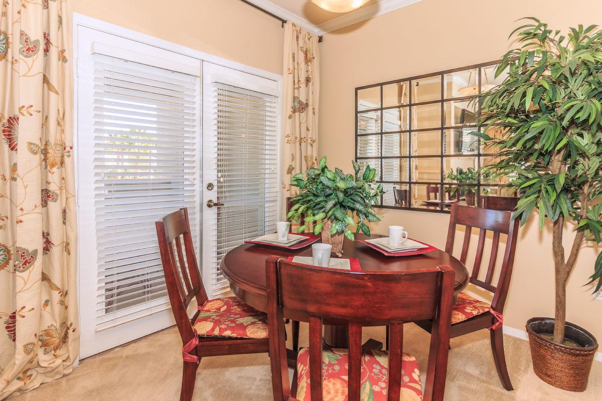 a living room filled with furniture and a large window