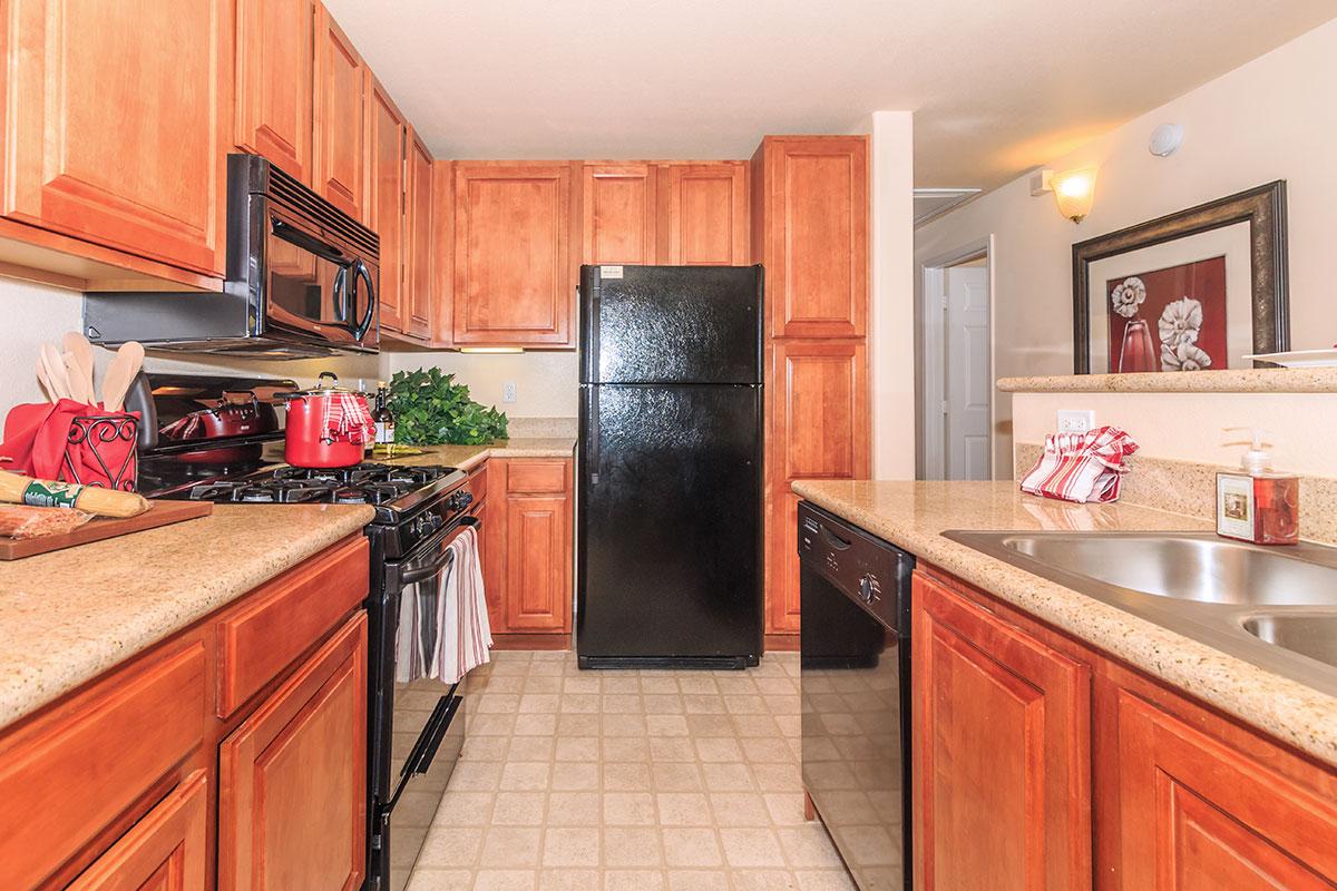 a kitchen with stainless steel appliances and wooden cabinets