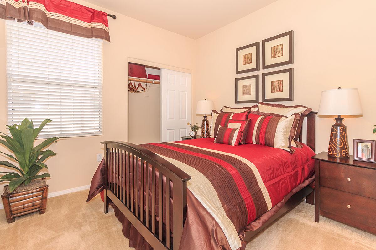 a bedroom with a large red chair in a room