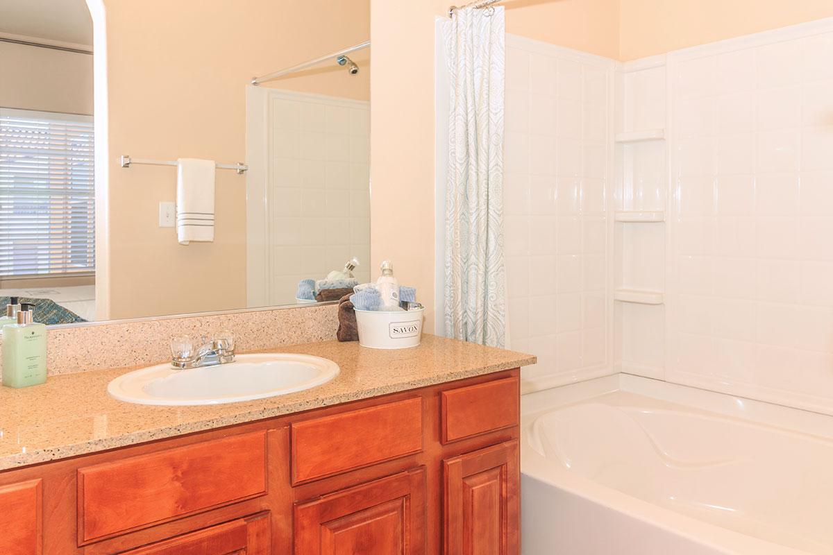 a kitchen with a sink and a mirror