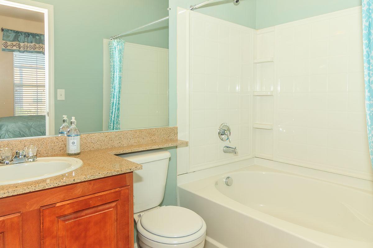 a white sink sitting under a window