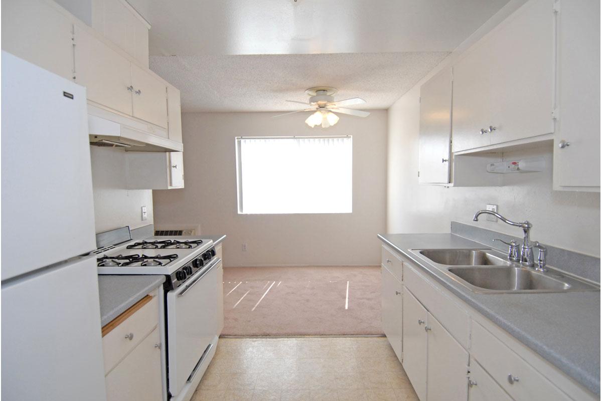 a kitchen with a stove sink and refrigerator