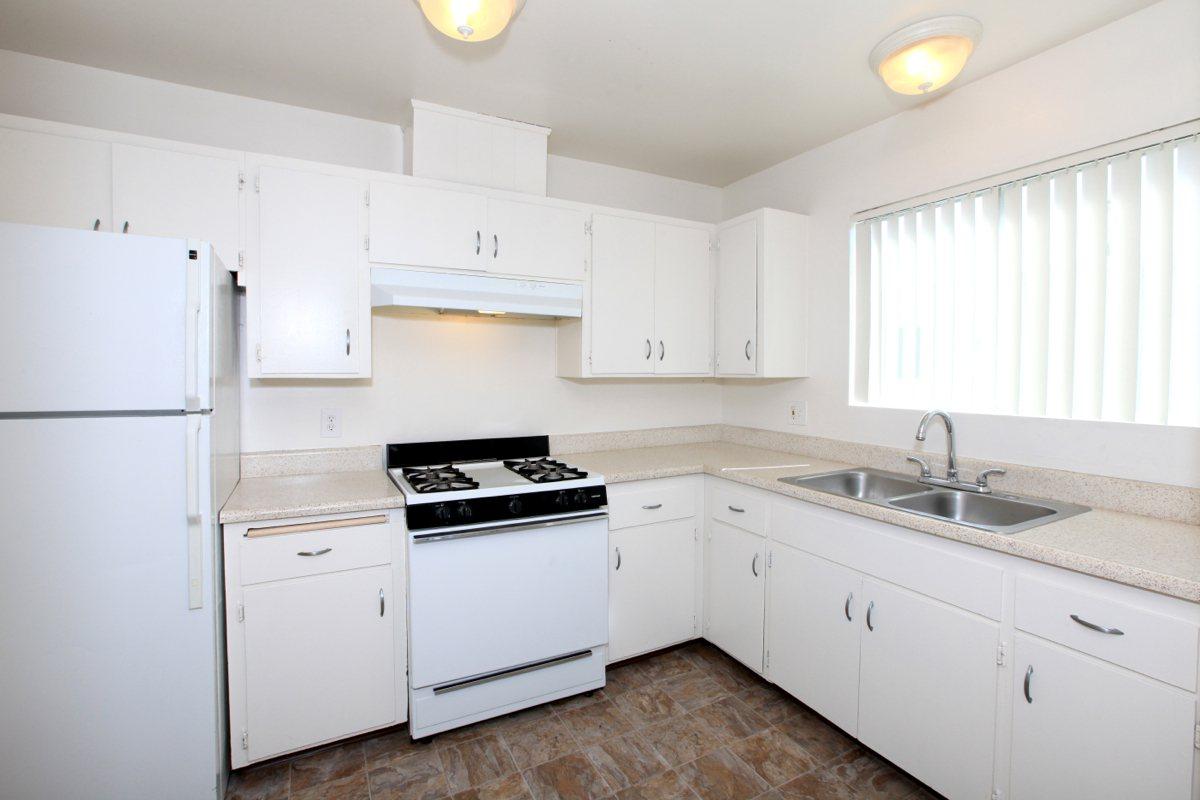 a kitchen with a stove and a refrigerator