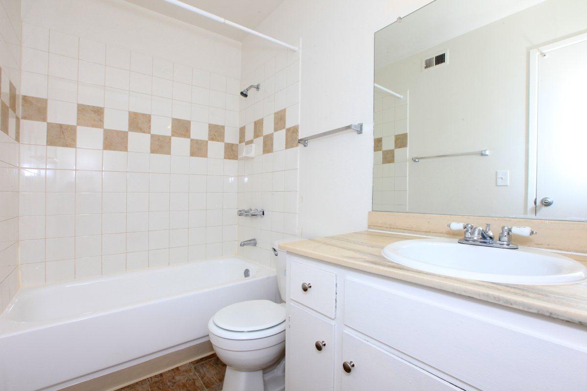 a large white tub sitting next to a sink