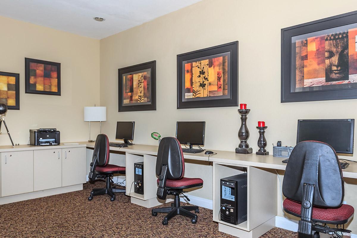 a living room with a desk and chair