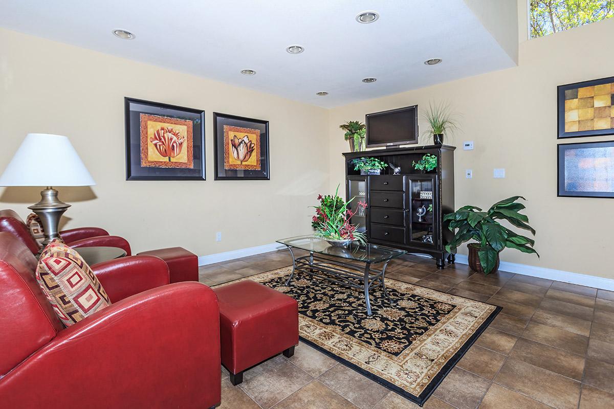 a living room filled with furniture and a flat screen tv