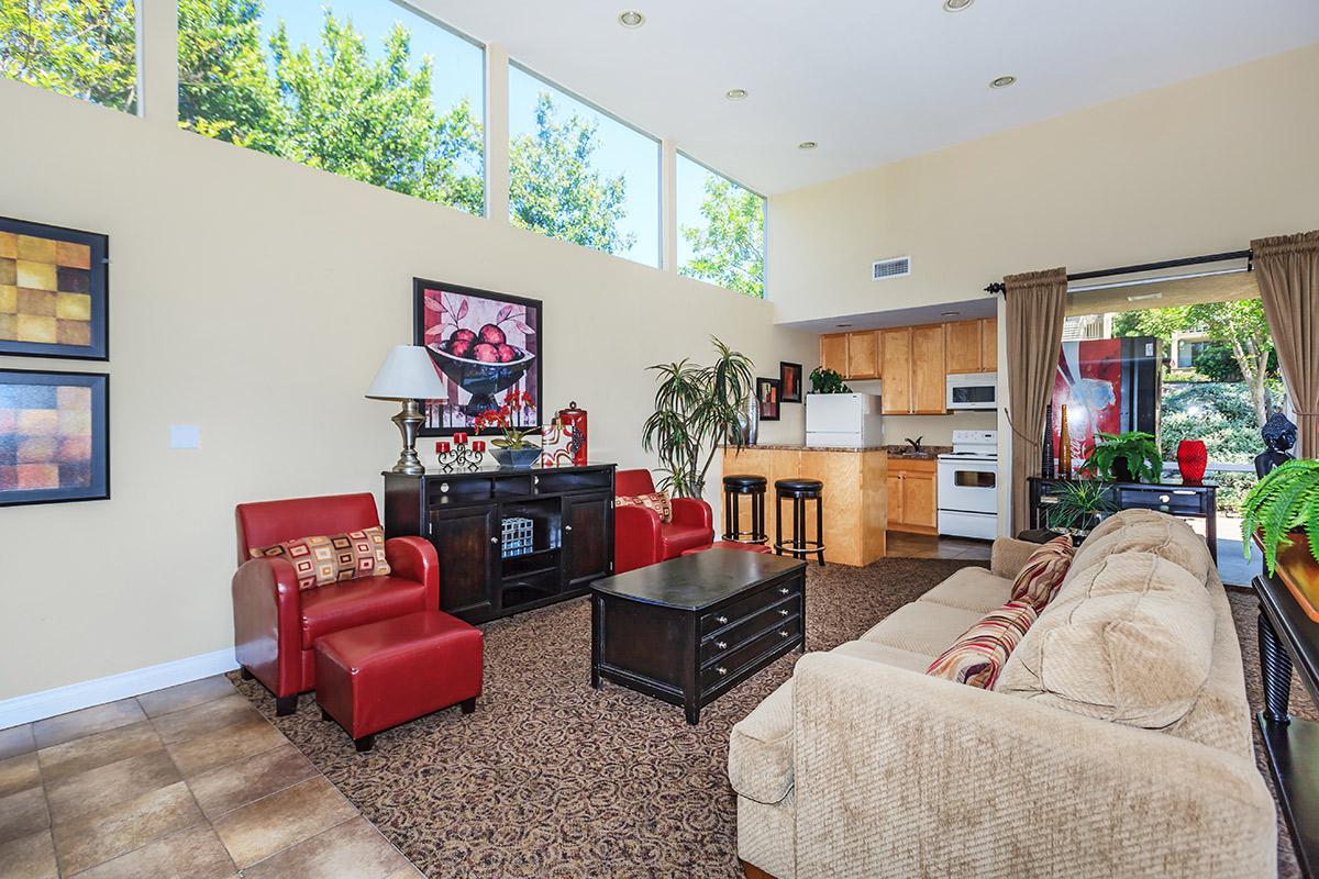 a living room filled with furniture and a flat screen tv