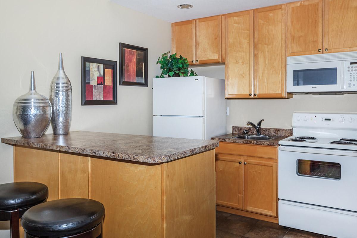 a stove top oven sitting inside of a kitchen