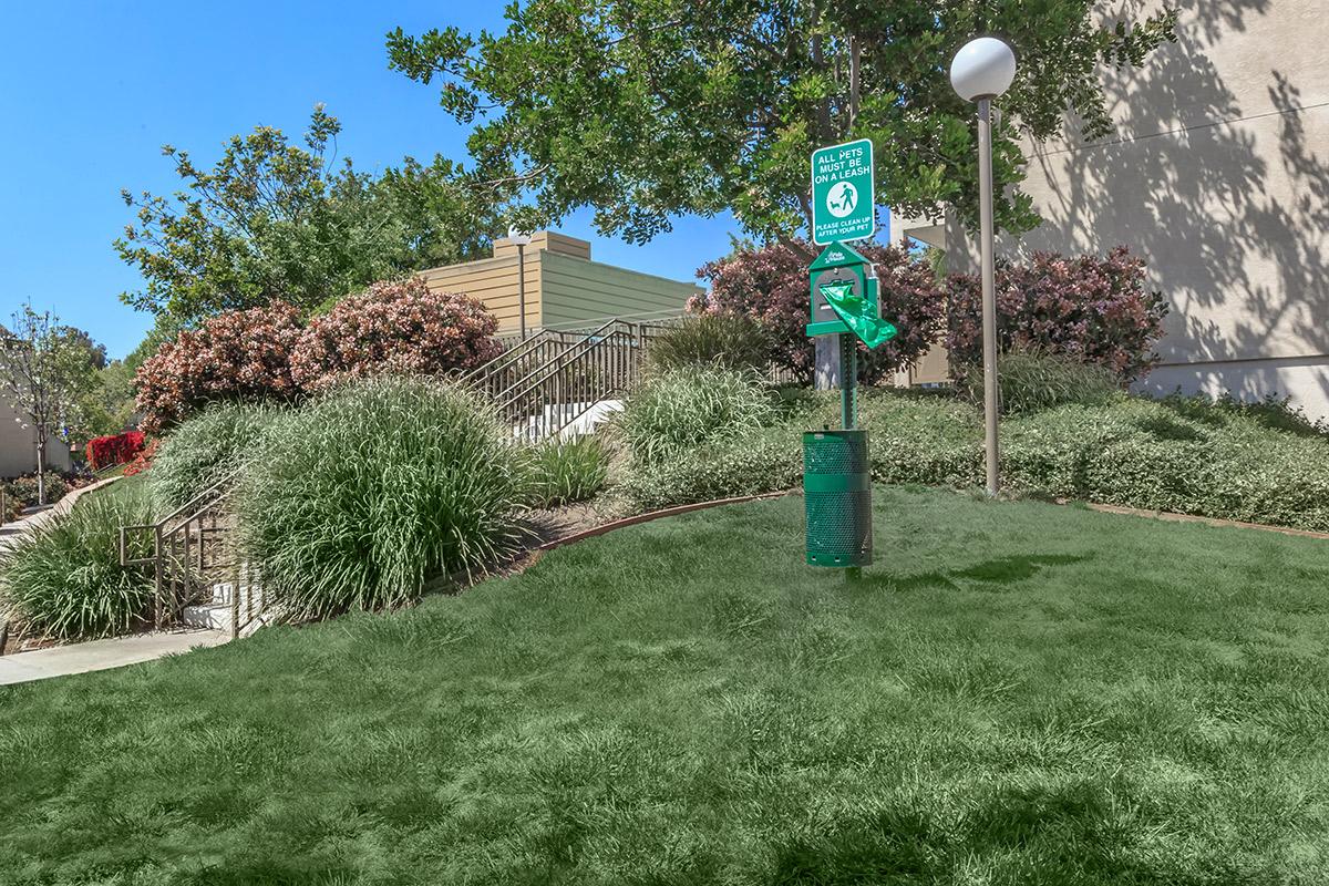 a sign on a grassy hill