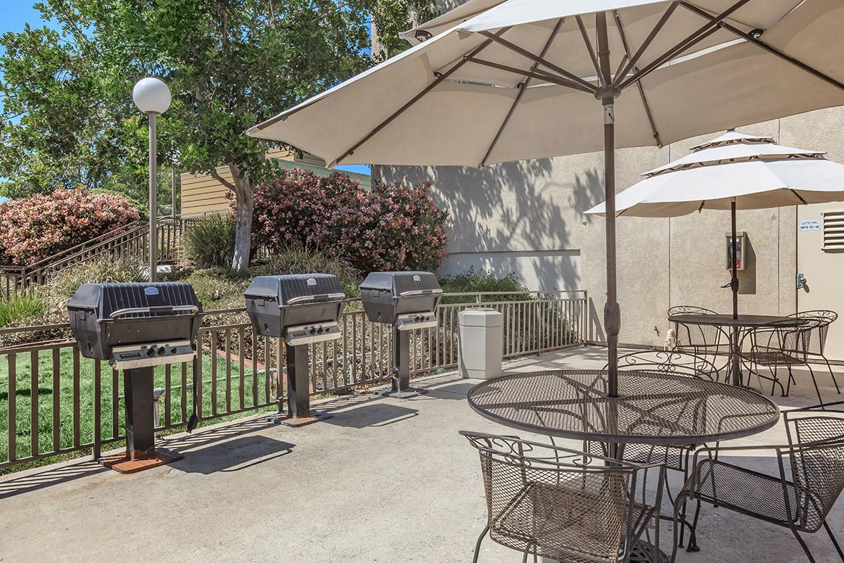 a group of lawn chairs sitting on top of a metal fence