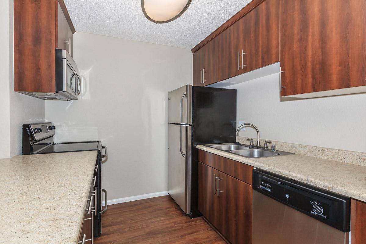 a kitchen with stainless steel appliances and wooden cabinets