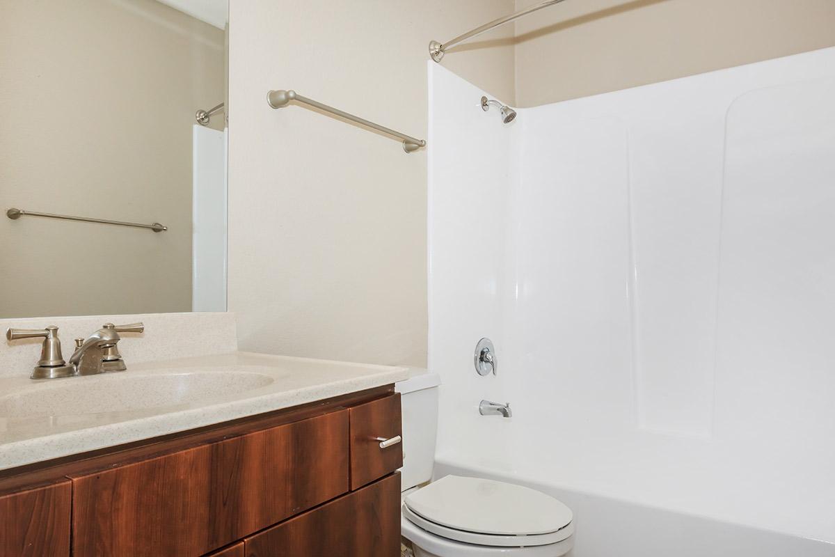 a white sink sitting next to a shower