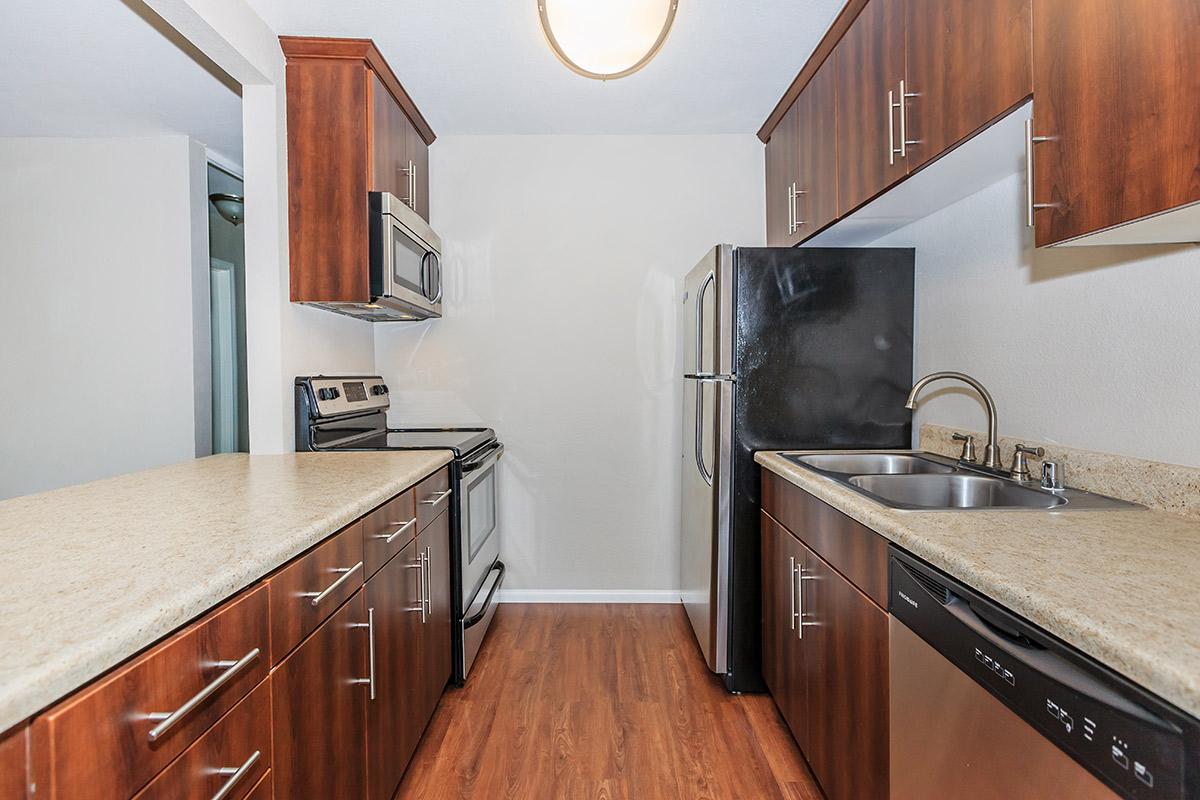 a kitchen with stainless steel appliances and wooden cabinets