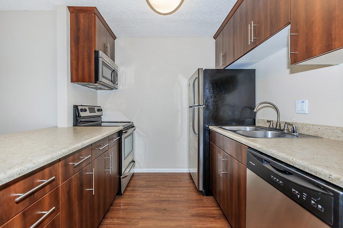 a kitchen with stainless steel appliances and wooden cabinets