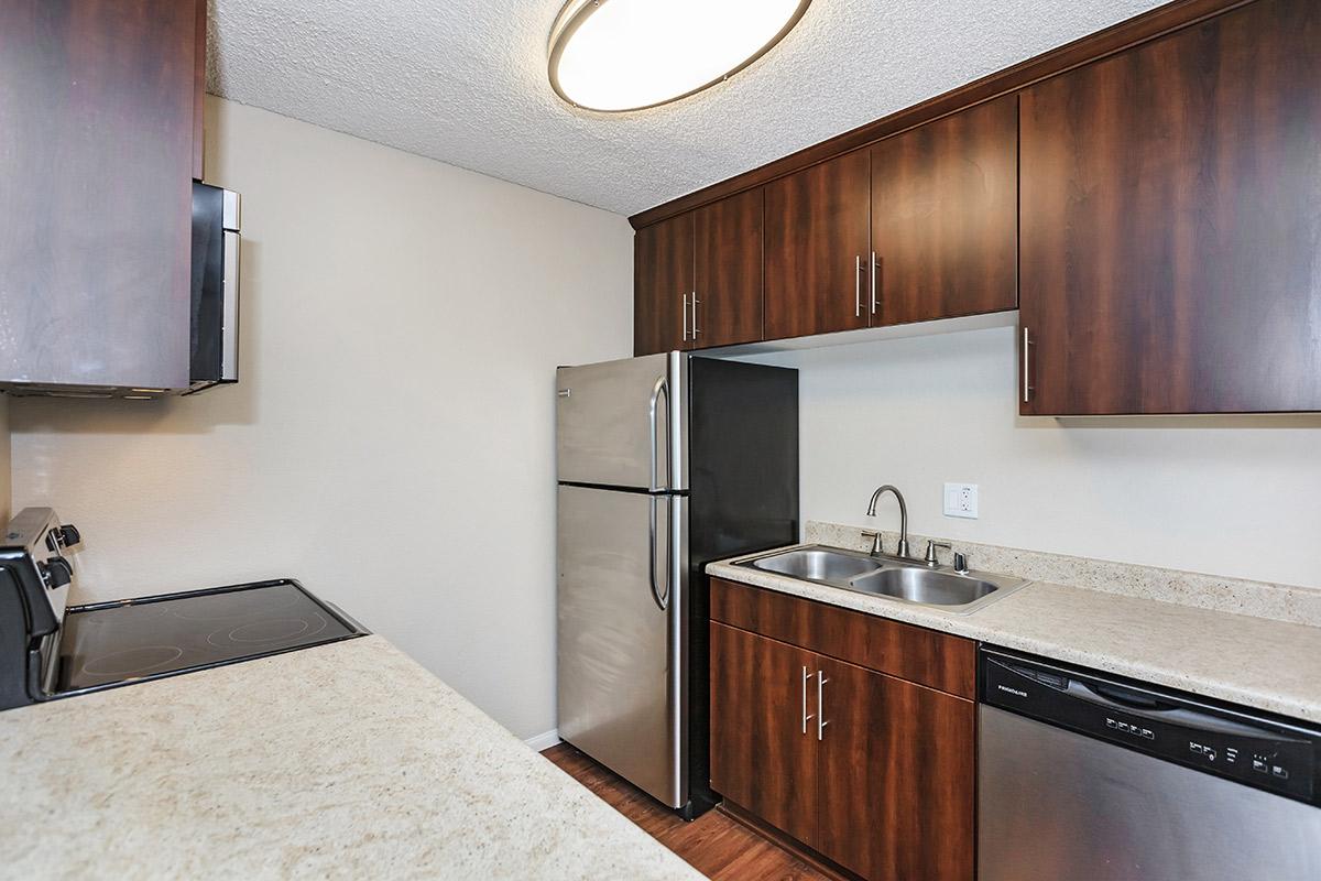 a kitchen with a sink and a mirror