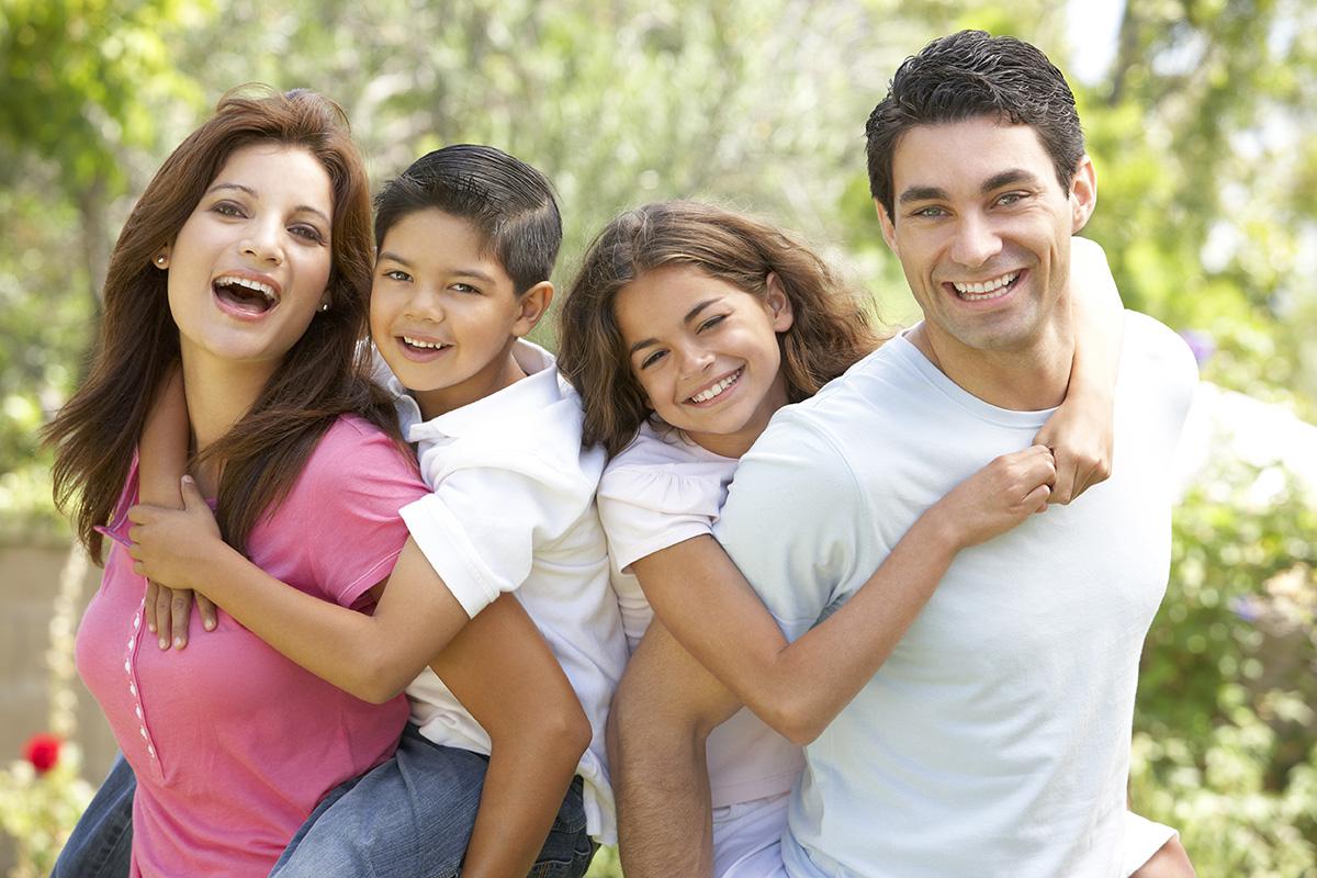 Happy family of four in a park .jpg