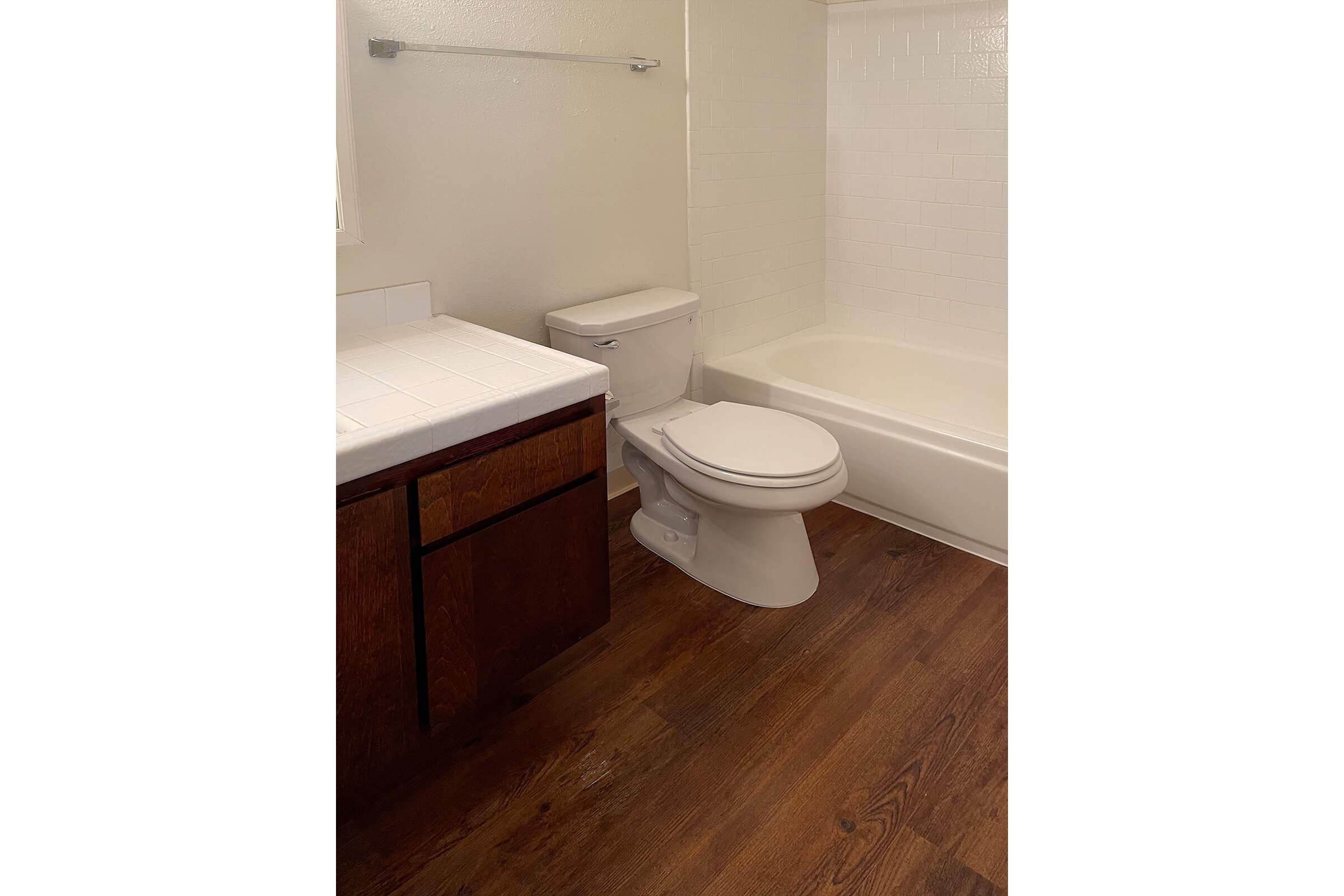 Vacant bathroom with wooden floors
