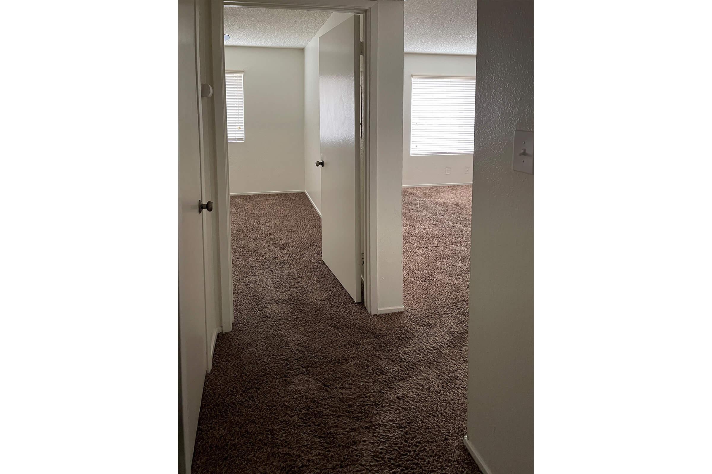 Hallway with carpet to bedroom
